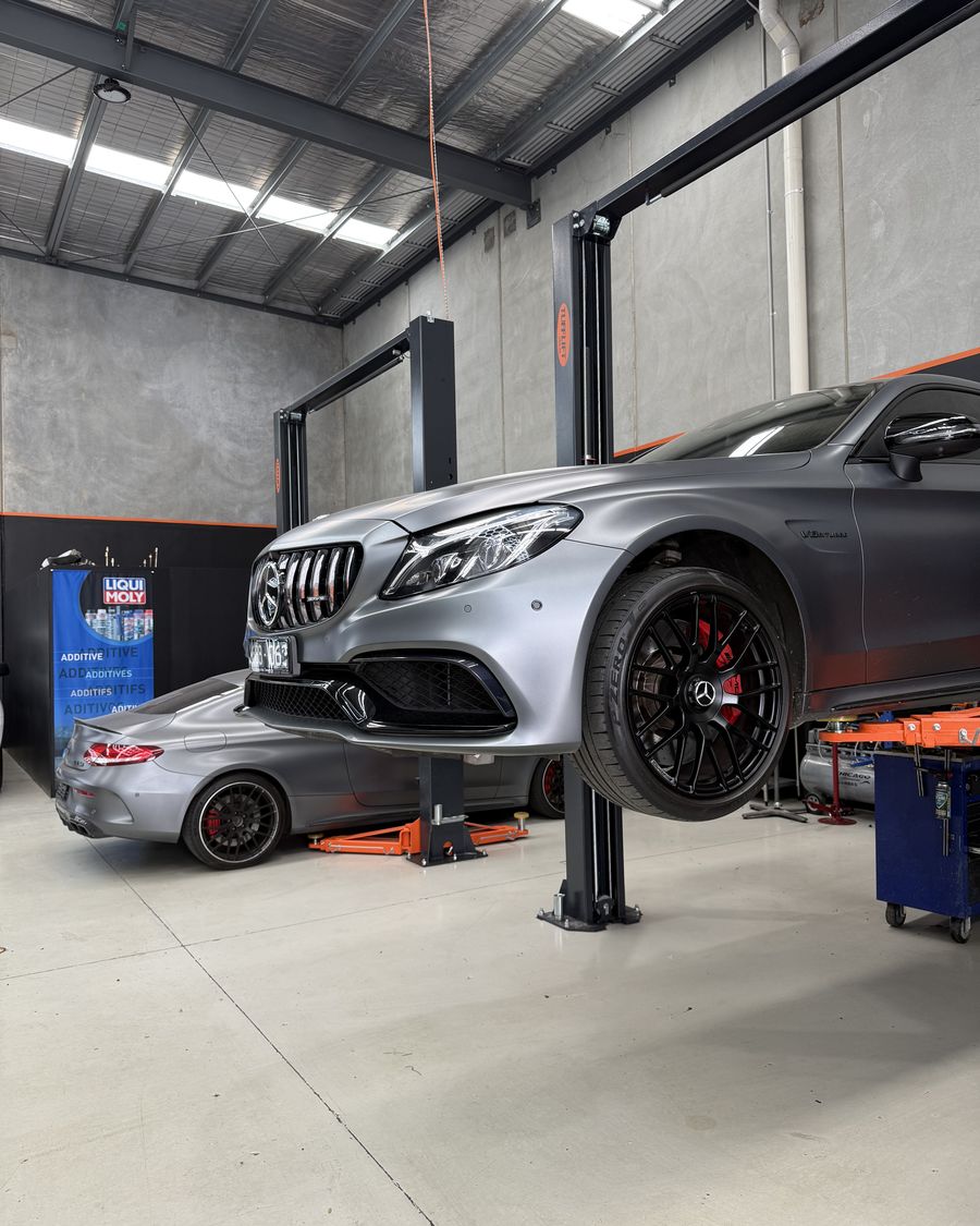 Mercedes-AMG C63 raised on the two-post hoist inside the Ignition Autohaus workshop