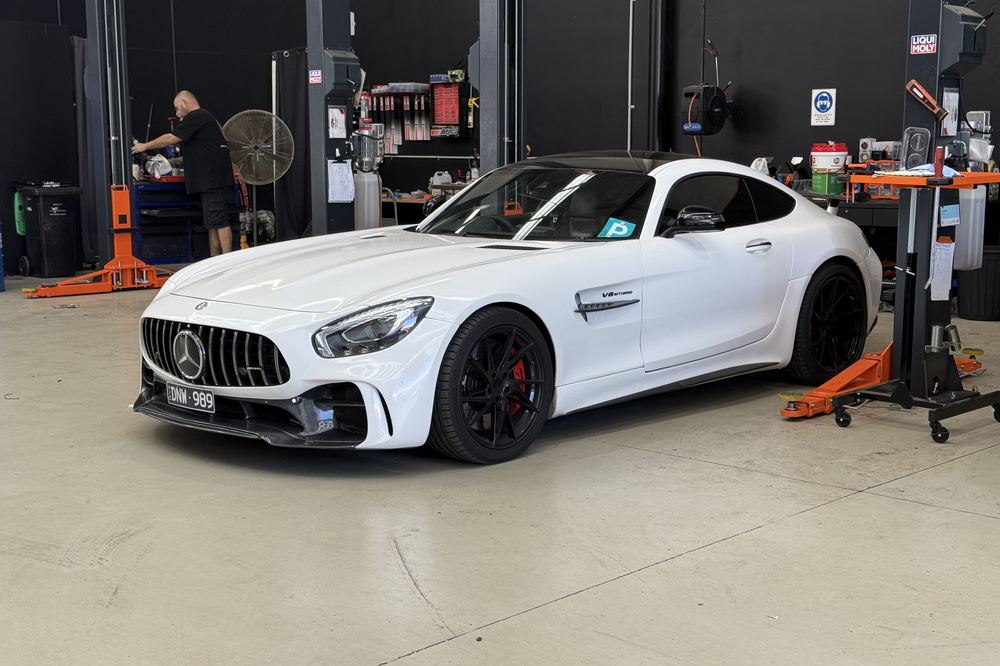 Mercedes-AMG GT R in the workshop bay with a technician working behind it