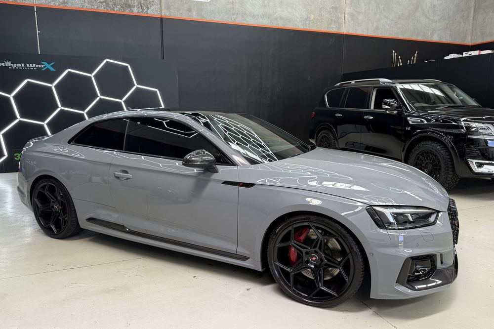 Audi RS5 in the finishing bay against the workshop feature wall